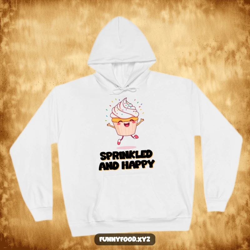 Funny cupcake hoodie with a cheerful cupcake character skipping energetically, adorned with flying sprinkles, offering warmth.